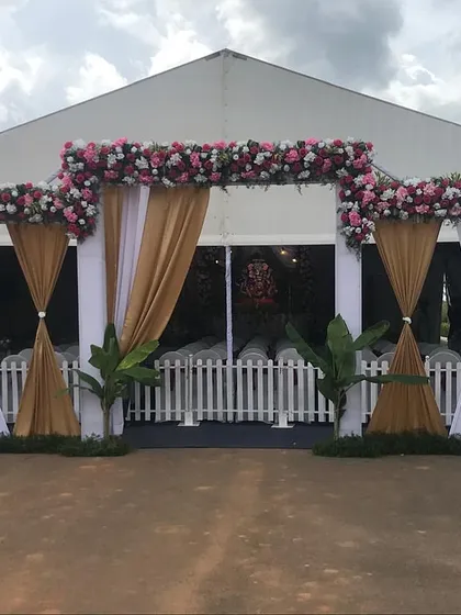 The entrance to the Ganesh Chaturthi celebration tent. We created an elegant entryway with white and gold drapes and a beautiful floral arch to welcome devotees into the sacred space.