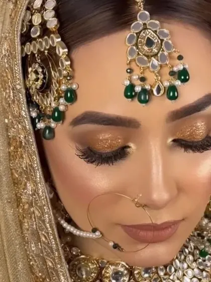 This close-up shows a glossy, golden bridal eye makeup. The shimmery and shiny finish gives a dewy, glamorous vibe that catches the light beautifully.
