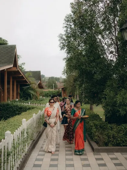 Capturing the ambiance of the wedding venue, with guests arriving along a picturesque pathway.
