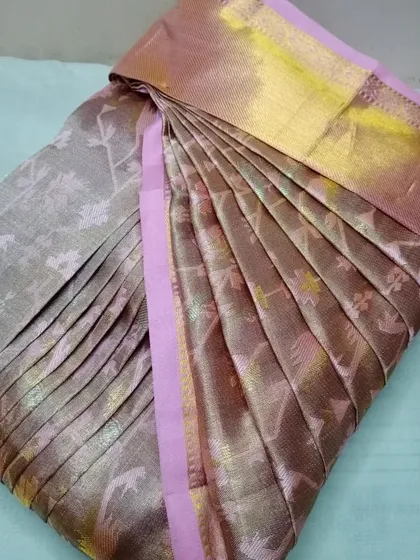 A brown and pink silk saree with intricate weaving.