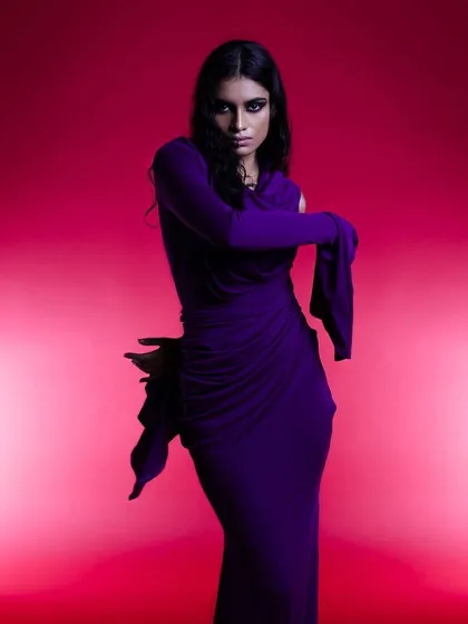 A dramatic shot for a fashion designer's collection. I created a smokey eye and styled the model's hair with wet, sculpted tendrils to match the avant-garde feel of the purple draped gown.