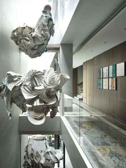 For us, art is a living, breathing element. This cascading installation, a collaboration with artist Ankon Mitra, combines the ancient Japanese dyeing technique of Shibori with the structural folds of origami to retell the story of Radha and Krishna, filling the home's central atrium with light, movement, and mythology.