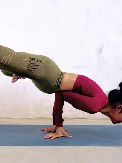 This is Mayurasana, or Peacock Pose. It's a powerful arm balance that strengthens the wrists and forearms and is known to aid digestion by massaging the abdominal organs.