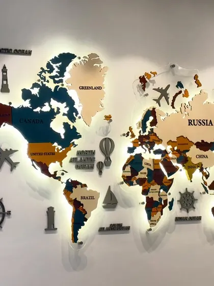 The world map with its warm backlighting on, creating a dramatic and sophisticated effect in the boardroom.