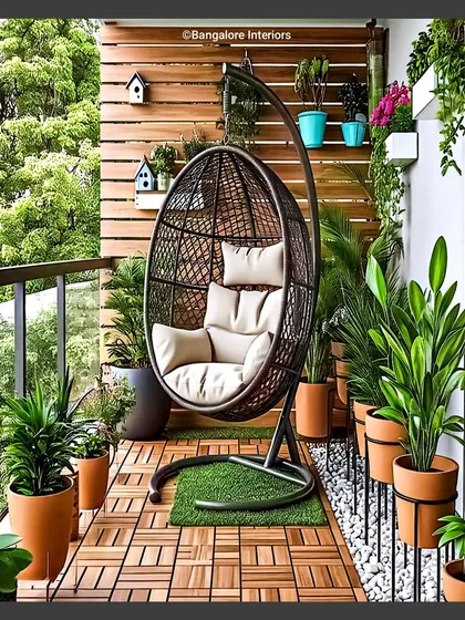 A hanging swing chair is one of my favorite ways to create a cozy boho corner. Here, I combined a comfortable rattan egg swing with warm wood decking, terracotta pots, and a slatted wood accent wall. This setup is ideal for anyone looking to create a personal nook for reading and unwinding.
