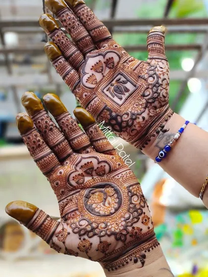 A beautiful design featuring a peacock in a central mandala on one hand and a lotus motif on the other. This asymmetrical approach allows for variety while maintaining a cohesive, intricate style.