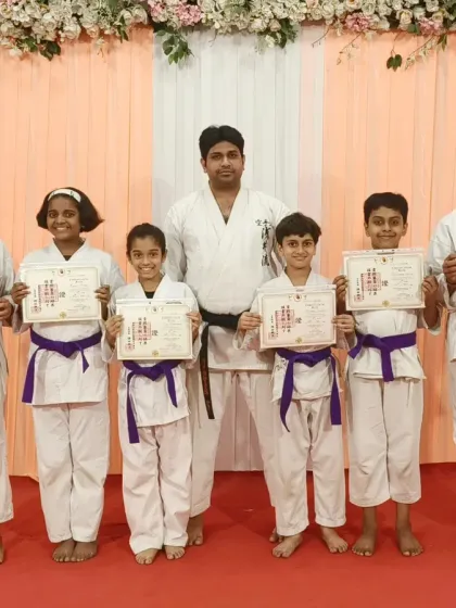 A group of students who have successfully graded to purple belt. This intermediate level requires a deeper understanding of karate principles and more complex kata.