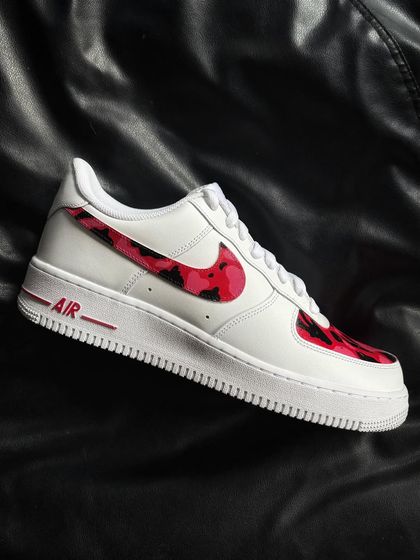 A side profile of the red camo custom sneaker.