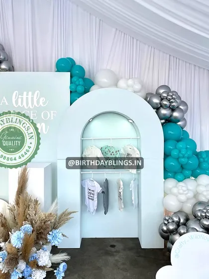 A unique detail from the "Little Piece of Heaven" shower, featuring a display arch with baby clothes.