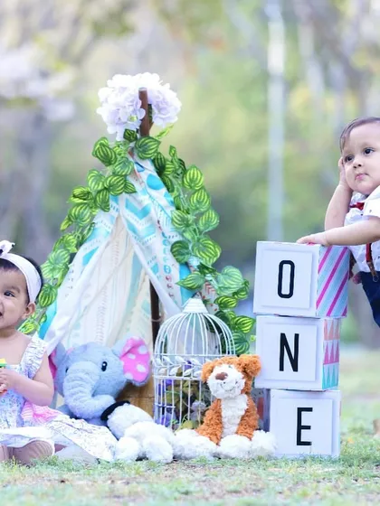 Double the joy. This outdoor first birthday photoshoot for twins was styled with a charming teepee and playful props to celebrate their big milestone together.