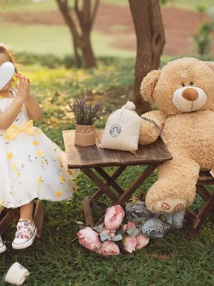 A playful moment during our teddy bear picnic. Outdoor sessions allow for so much movement and natural expression. (Face hidden for privacy).