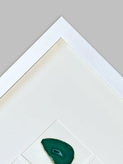 A corner detail with a green 'Emerald' agate stone. The clean, 90-degree corner of the white frame highlights the quality of the construction.