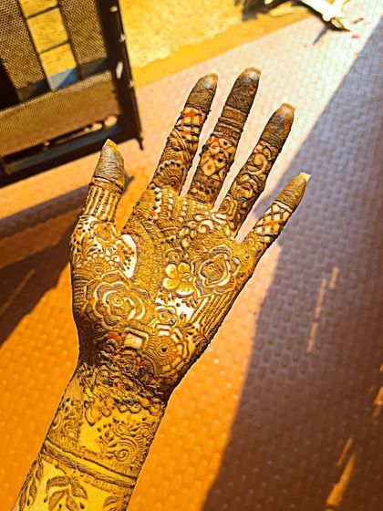 The beauty of a mature henna stain in the sunlight. This photo shows the deep reddish brown color of a full coverage design a day or two after application.