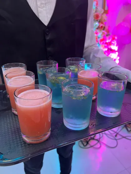 A tray of colourful welcome drinks being served at a 5th birthday party. I can create fun and attractive mocktails for any themed event.
