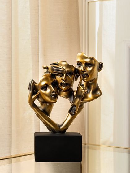 This abstract sculpture, titled 'Mystery & Intrigue', features three faces depicting the classic "see no evil, hear no evil, speak no evil" motif. Finished in antique gold, it's a guaranteed conversation starter.