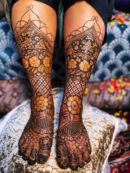 Your bridal look isn't complete without beautiful henna on your feet. I designed this symmetrical floral and mesh pattern to adorn the bride's feet, ensuring every detail is perfect.