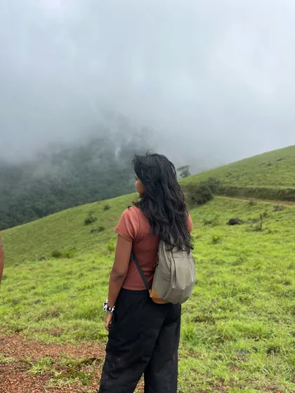 A trekker looks out over the misty hills of Kodachadri.