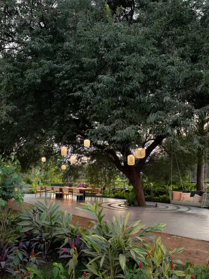 We designed this outdoor space to be a place for gathering and unwinding. Nestled under the shade of a large tamarind tree, the al fresco dining area and swing create a tranquil garden retreat for family and friends.