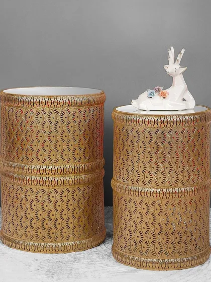 This set of two nesting side tables features a beautiful perforated metal design with an antique gold finish. They can be used together for a layered look or separately where needed, offering great versatility.