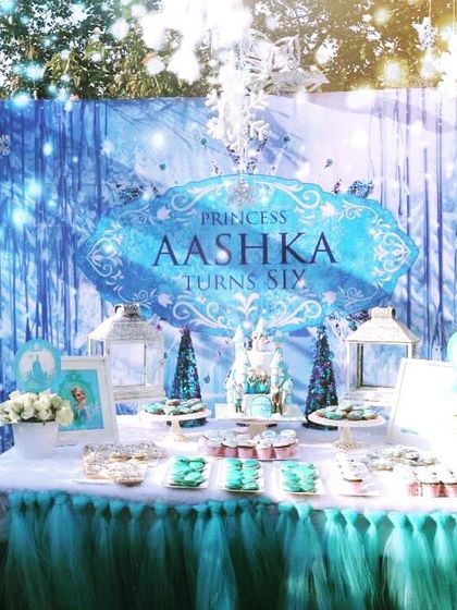 A "Frozen" themed dessert table that brings the magic of winter to life. The shimmering blue backdrop and snowflake details created a sparkling ice palace for the birthday princess.