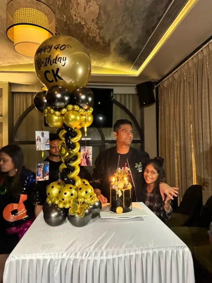 Another shot of the birthday boy and his family during the cake cutting. The black and gold theme adds a touch of luxury to the event.