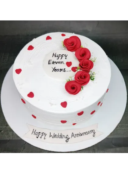 Eleven years of love celebrated with this classic choco-vanilla anniversary cake. It's decorated with simple red hearts and beautiful fondant roses.