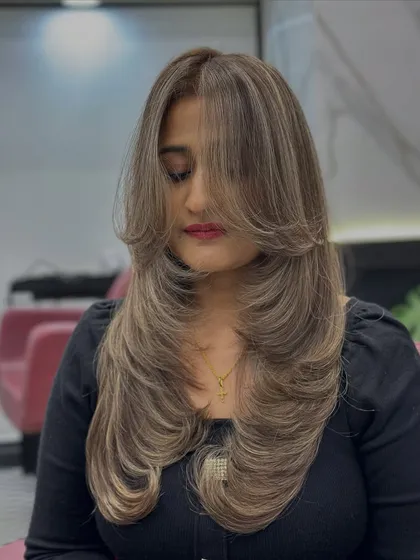 This is what I call an "expensive" blonde. I created this stunning ash blonde look with a global color base and carefully placed highlights, finished with a layered haircut to make the color pop.