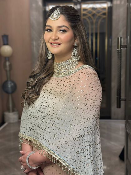 A happy and radiant bride-to-be. The makeup is designed to look flawless and glowing from every angle, perfect for celebrating this special milestone.