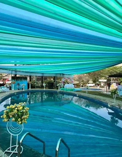 We can transform any space, including a poolside area, into a spectacular event venue. For this Haldi ceremony, we installed a beautiful blue and green fabric canopy over the pool, which not only looked stunning but also provided shade for the guests.