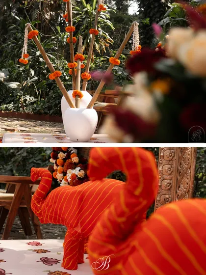 A detail shot of the scrap fabric elephants and the bamboo sticks adorned with marigolds, showcasing the creative use of simple and upcycled materials.