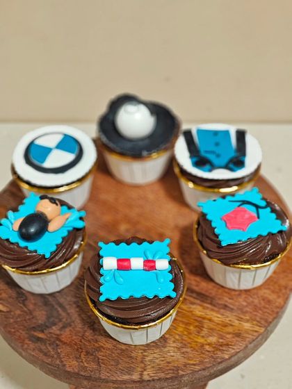 The full set of six custom cupcakes, combining themes of swimming and motorcycling. It's a unique and personal way to celebrate a relationship.