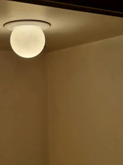 The Pint-Dot downlight installed, casting a soft, warm glow. This fixture is perfect for creating ambient light in niches, hallways, or as part of a larger, layered lighting scheme.