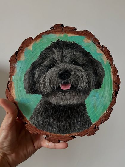 I love the texture and character that painting on wood slices provides. This portrait of a happy black poodle mix shows how the natural grain of the wood can complement the artwork.