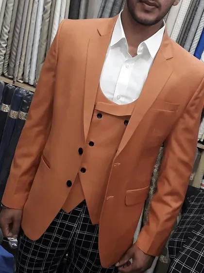 A unique combination of a solid orange three piece suit paired with checked trousers. I can mix and match fabrics to create a custom look that is entirely your own.