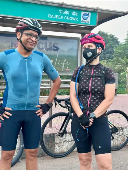 A candid chat between two members at a bus stop during a ride break.
