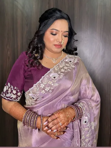 A candid moment showing the soft, romantic makeup and hairstyle chosen for her engagement ceremony.