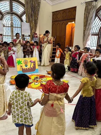 Community and culture are woven into everything we do. During our Onam celebration, children in traditional attire hold hands around a beautiful pookalam they helped create. These shared experiences build friendships and a deep appreciation for India's diverse traditions.