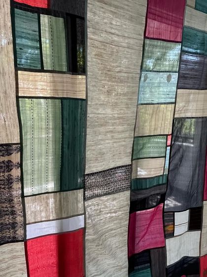 An artistic close-up of the Pojagi divider, emphasizing the interplay of light, color, and texture.