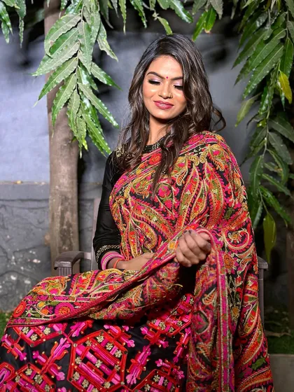 A happy and relaxed portrait of the client in her full party attire.