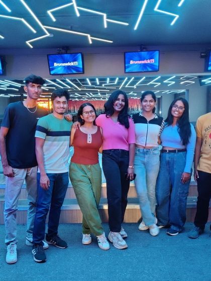 A group of friends posing at the bowling alley.