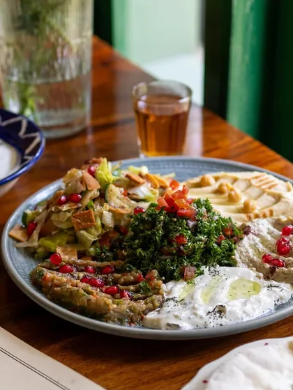A close-up of the beautiful mezze platter at Cafe Zubaan. This shot highlights the freshness of the ingredients and the vibrant colors of the dish.