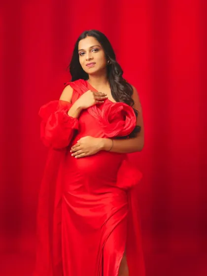 Embrace your power and passion in this stunning red gown. Featuring bold floral shoulder details and a graceful flow, this dress is designed for the mom-to-be who wants to make a vibrant and confident statement.