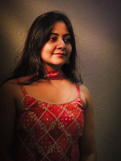 A warm, softly lit portrait from an indoor bridal session. Her gentle smile and the soft focus create a timeless and elegant look.