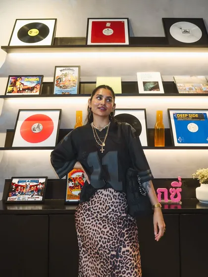 A full-length shot showing my street style look, pairing an oversized jersey with a leopard print skirt. I love mixing athletic and chic pieces.