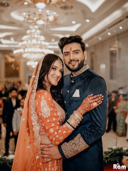 A classic portrait of the happy couple at their engagement ceremony. Their warm embrace and smiles towards the camera make for a perfect photo to share with family and friends.