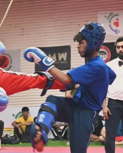 A kickboxer connects with a precise kick to the body. Our training focuses on accuracy and power to score points effectively in competition.