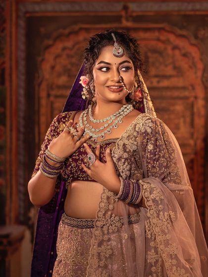 A playful and happy moment in one of my custom bridal lehengas. The combination of a rich purple velvet blouse and a lighter embroidered skirt creates a balanced and beautiful look, perfect for a modern bride.