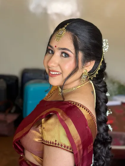 A side profile showing her beautiful braided hairstyle and the soft makeup look.