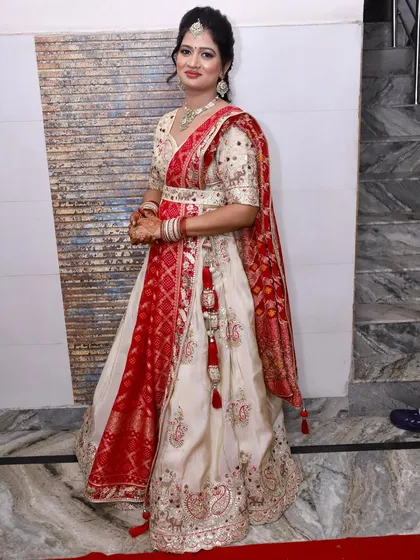 The full view of this beautiful party outfit. The makeup enhances her features and complements the intricate embroidery.