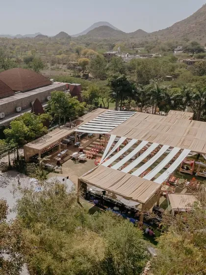 A bird's-eye view of the 'Rajasthani Folklore' Mehendi, showcasing the scale of the event and the beautiful natural surroundings.